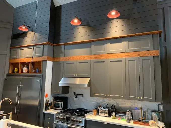 Modern charcoal kitchen cabinetry with brass hardware