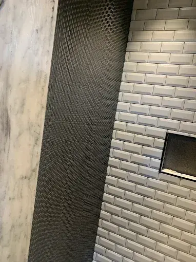 Subway tile fireplace surround with dark accent wall